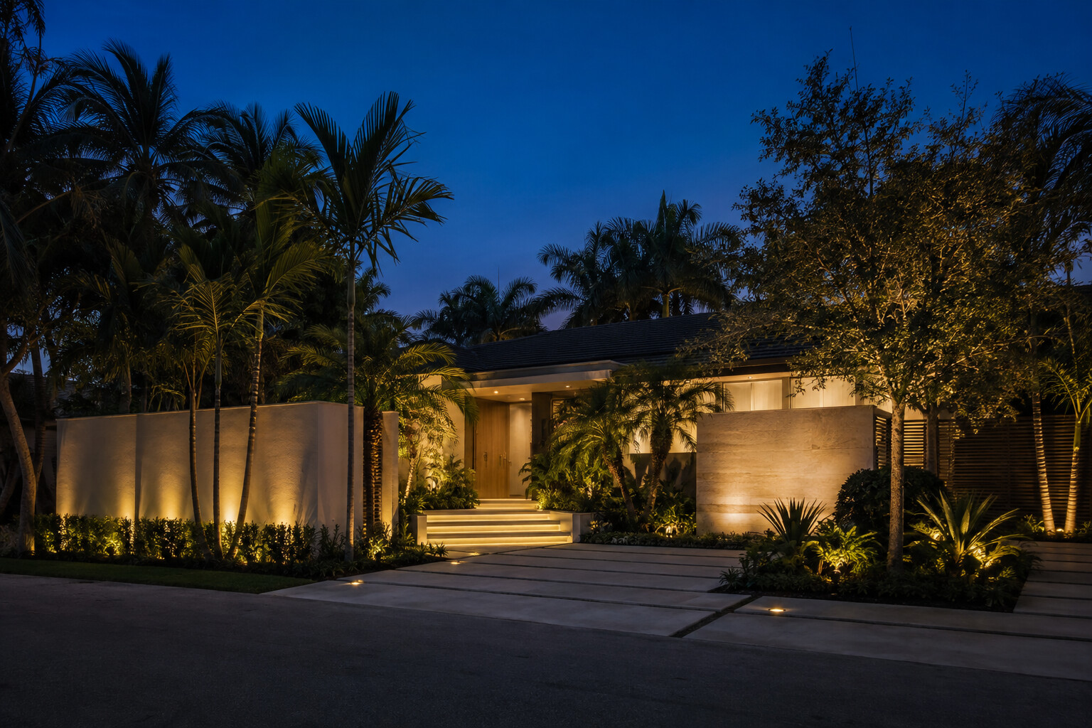 Warm architectural lighting at a tropical home entrance